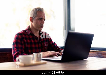 Handsome Persian man relaxing at the coffee shop Stock Photo