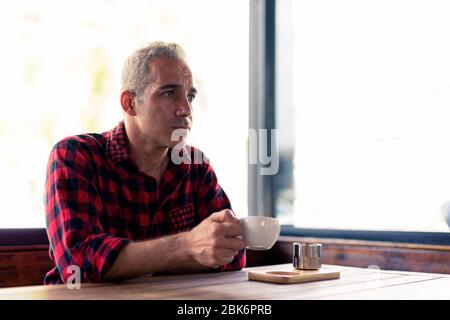 Handsome Persian man relaxing at the coffee shop Stock Photo