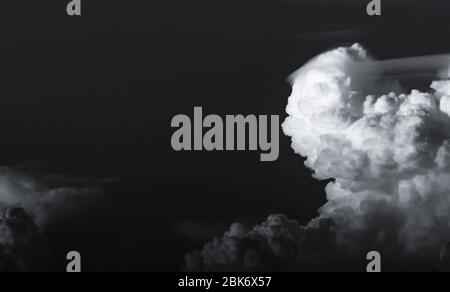 Dark dramatic sky and clouds. Background for death and sad concept. Black sky and white fluffy clouds. Sad and moody sky. Beauty in nature. Dead Stock Photo