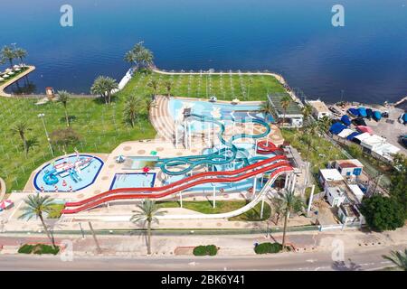 Corona Virus lockdown, Aerial image of a large and empty Water park with various Water slides and pools due to government guidelines. Stock Photo