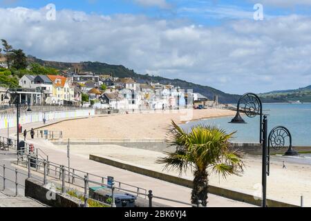 Lyme Regis, Dorset, UK.  2nd May 2020. UK Weather.  A view of the almost deserted beach and seafront at the seaside resort of Lyme Regis in Dorset on a day of warm sunny spells during the coronavirus pandemic lockdown   Picture Credit: Graham Hunt/Alamy Live News Stock Photo