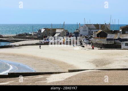 Lyme Regis, Dorset, UK.  2nd May 2020. UK Weather.  A view of the almost deserted beach at the seaside resort of Lyme Regis in Dorset on a day of warm sunny spells during the coronavirus pandemic lockdown   Picture Credit: Graham Hunt/Alamy Live News Stock Photo