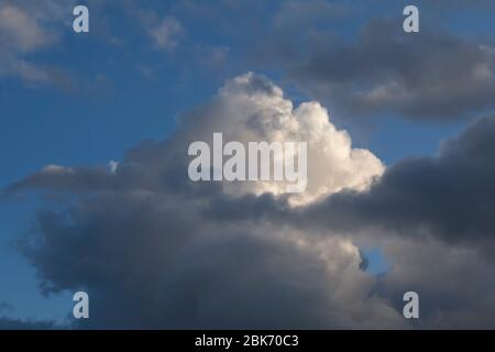 white fluffy cloud in a stormy blue sky Stock Photo