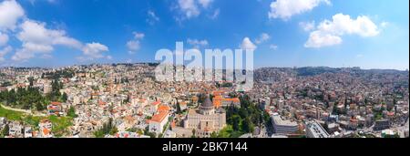 Aerial panorama of the Basilica of the Annunciation over the old city houses of Nazareth Stock Photo