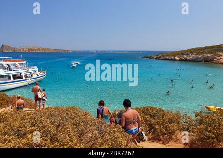 Agios Nikolaos, Greece, August 20, 2013: Picturesque bay near the city attracts tourists on boats and motor ships. Stock Photo