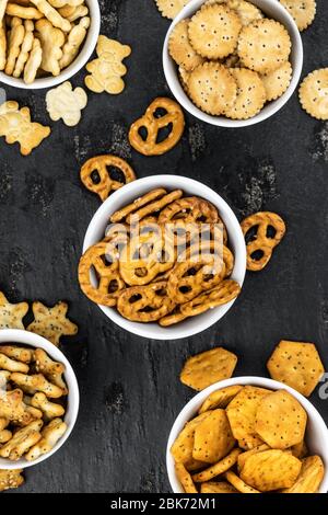 Portion of mixed Snacks on dark background (detailed close up shot; selective focus) Stock Photo