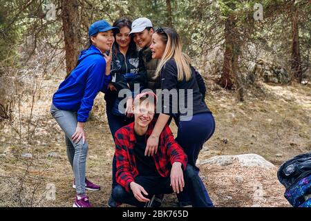 Bishkek, Kyrgyzstan - April 9, 2019: International mointain day. Tourists stopped to rest during a hike in the mountains. Stock Photo