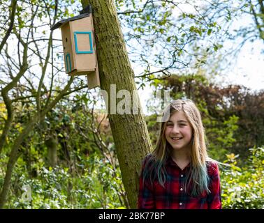 Camptoun, East Lothian, Scotland, United Kingdom. 2nd May, 2020. A community in lockdown: residents in a small rural community show what life in lockdown is like for them. Pictured: Georgie, aged 11 years has learned woodworking skills by building a bird box