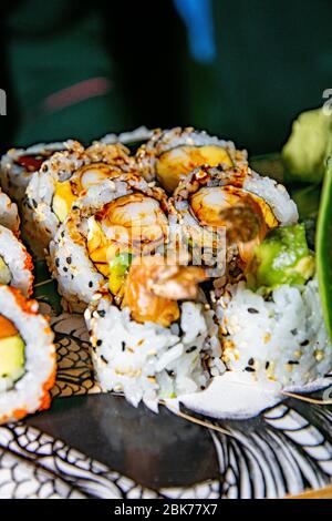 a portion of tempura prawn sushi served on top of a skateboard Stock Photo
