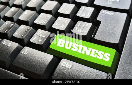 Black keyboard with one green key labeled by business sign. Stock Photo