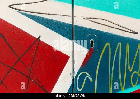 Colorful Graffiti. Painted wall. Paintings on the electrical box. Symmetrical patterns. Stock Photo