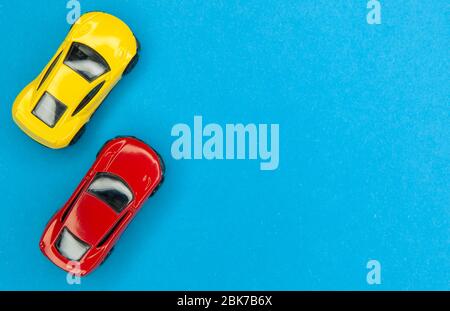 Yellow and red toy cars on a blue background, top view. Stock Photo