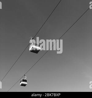 Lisbon, Portugal - January 01,2020: Cable ferry cars are one of the touristic activities in the Expo98, Lisbon. Black and white photo filtered. Stock Photo
