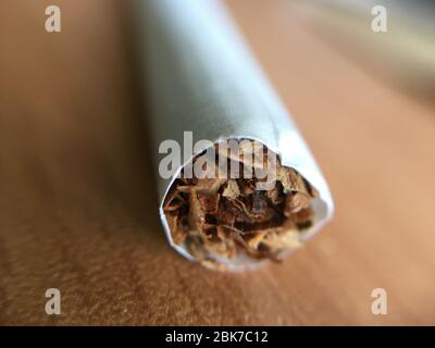 Macro photography of cigarette, Focus point on tobacco inside the cigarette. Stock Photo