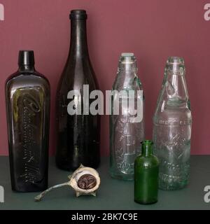Sleeping mouse beneath empty bottles Stock Photo