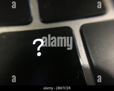 Question mark at the computer key Stock Photo