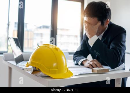 Engineer thinking and serious about fail business and construction falling down Stock Photo