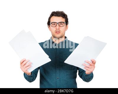 Perplexed businessman looking stunned to camera as holds different paper documents in both hands isolated on white background. Puzzled business person Stock Photo