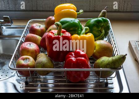 Fresh Fruit and Vegetables drying naturally on draining board after antiviral wash in soapy water Stock Photo