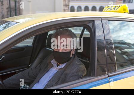 Beijing, Greece. 22nd Apr, 2020. Taxi driver Kostas Karpetopoulos poses for a photo as he works in Athens, Greece, April 22, 2020. Many people have been sticking to their posts as the world fights against the COVID-19 epidemic. Credit: Marios Lolos/Xinhua/Alamy Live News Stock Photo