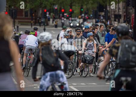 London, UK. 2nd May 2020. On the first Saturday in May, members of public are seen on bicycles at Parliament Square in London. The society has been ordered to stay at home and limit social contacts. Only essential travel is allowed due to the outbreak of coronavirus. Credit: Marcin Nowak/Alamy Live News Stock Photo