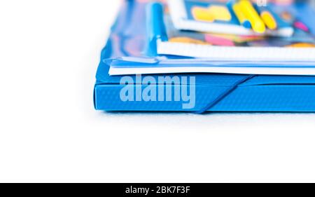 Education background, plastic folder, books and notebook with pens, workplace at home during the pandemic. The quarantine concept of stay home stop co Stock Photo