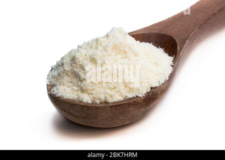 Full  fat powdered milk in wooden spoon isolated on white Stock Photo