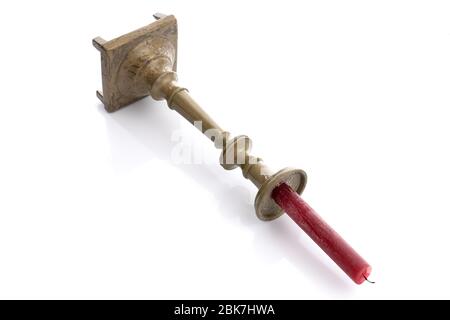 Old copper vintage candlestick with red candle isolated on white Stock Photo