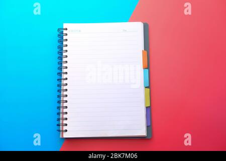 empty notepad on color background , Top view  Stock Photo