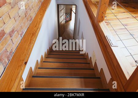 Wooden staircase in coworking space with wall Stock Photo