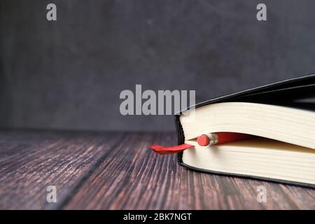 Closed diary with pencil on wooden background  Stock Photo