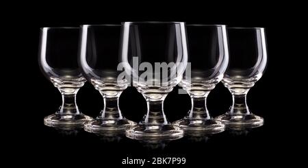 Set of empty glasses of light beer with foam isolated on a black background Stock Photo