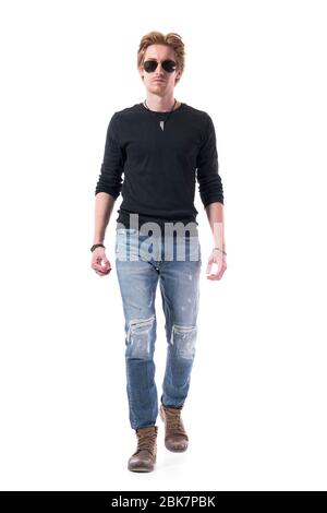 Serious confident macho red hair man fashion model walking towards camera with sunglasses. Full body isolated on white background. Stock Photo