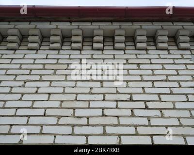 The Wall from white brick close-up. The Laying by even rows.Type from below Stock Photo