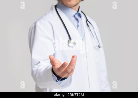 Unrecognizable Male Doctor Holding Virtual Object In His Hand, Cropped Stock Photo