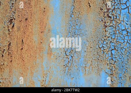 Metal texture with scratches and cracks Copy space. Cracked blue paint, rusty metal surface. The rust on the steel plate is painted in blue. Stock Photo