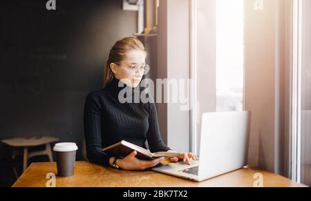 Woman works remotely online from home while quarantine coronavirus is in effect. Concept of checking mail, blogger Stock Photo