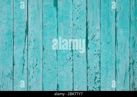 Cracked blue wood background. Timber vertical plank, scratched surface. Turquoise wooden fence background. Copy space. Vintage texture boards. Stock Photo
