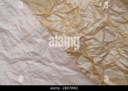 Crumpled brown paper texture top view. wrapping paper closeup. Creased sheet background. Two types of paper of different density and coating are folde Stock Photo