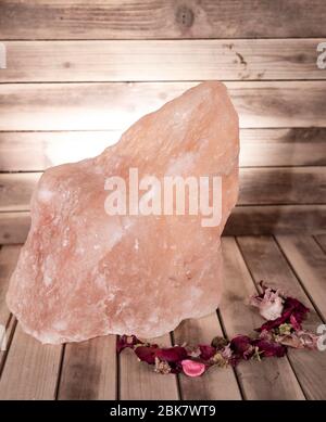 pink salt on a wooden table and backdrop lamp wellness Stock Photo