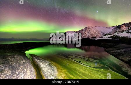 Northern Lights over the Ersfjord Beach and Norwegian sea. Senja island at night, Norway, Europe Stock Photo
