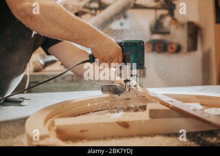 Joinery, woodworking and furniture making, professional carpenter cutting wood in carpentry shop, industrial concept Stock Photo