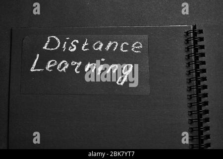 Distance learning. Headline on black paper Stock Photo - Alamy