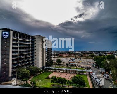 Beautiful and tall Standard bank buildings in Simmonds street Selby Johannesburg CBD area under a cloudy and sunset sky Stock Photo