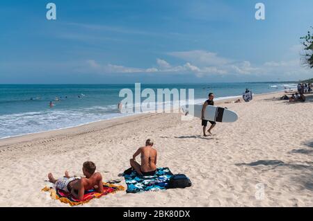 Tourists on Kuta Beach Bali Indonesia Stock Photo