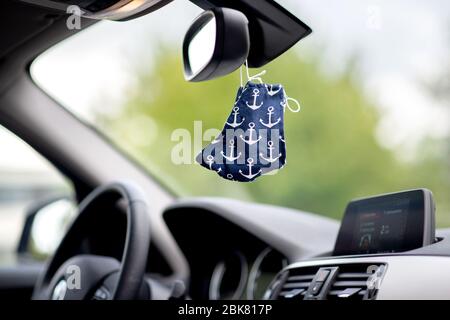 Oldenburg, Germany. 02nd May, 2020. A blue cloth mask with anchor motif hangs from a rear-view mirror in a car. In Lower Saxony, masks are mandatory for the retail trade and public transport. Credit: Hauke-Christian Dittrich/dpa/Alamy Live News Stock Photo