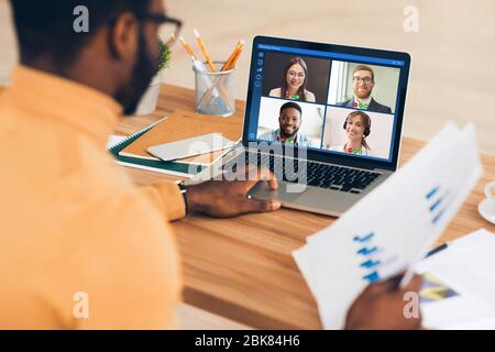African American employee having online business conference with colleagues at home office, collage Stock Photo