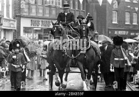 The annual Knutsford Royal May Day procession in 1976 in Knutsford, Cheshire, England, United Kingdom. It traditionally includes a fancy-dress pageant of children in historical or legendary costumes with  horse-drawn carriages. A horse-drawn carriage with children dressed as soldiers. Stock Photo