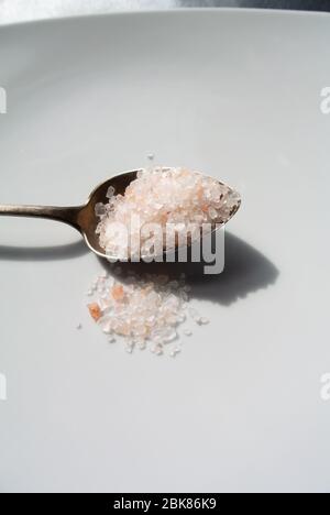 A spoon of Pink Himalayan Salt on white background Stock Photo