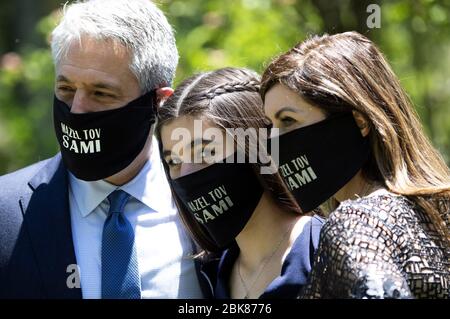 Potomac, United States. 02nd May, 2020. Sami Snow poses with her parents as they wear customized masks during her drive by Bat Mitzvah celebration at her house in Potomac, Maryland on Saturday, May 2, 2020. The family held a small ceremony at the home with the Rabbi officiating online followed by a surprise drive by Mitzvah celebration due to the Coronavirus (COVID-19) social-distancing requirements. Photo by Kevin Dietsch/UPI Credit: UPI/Alamy Live News Stock Photo